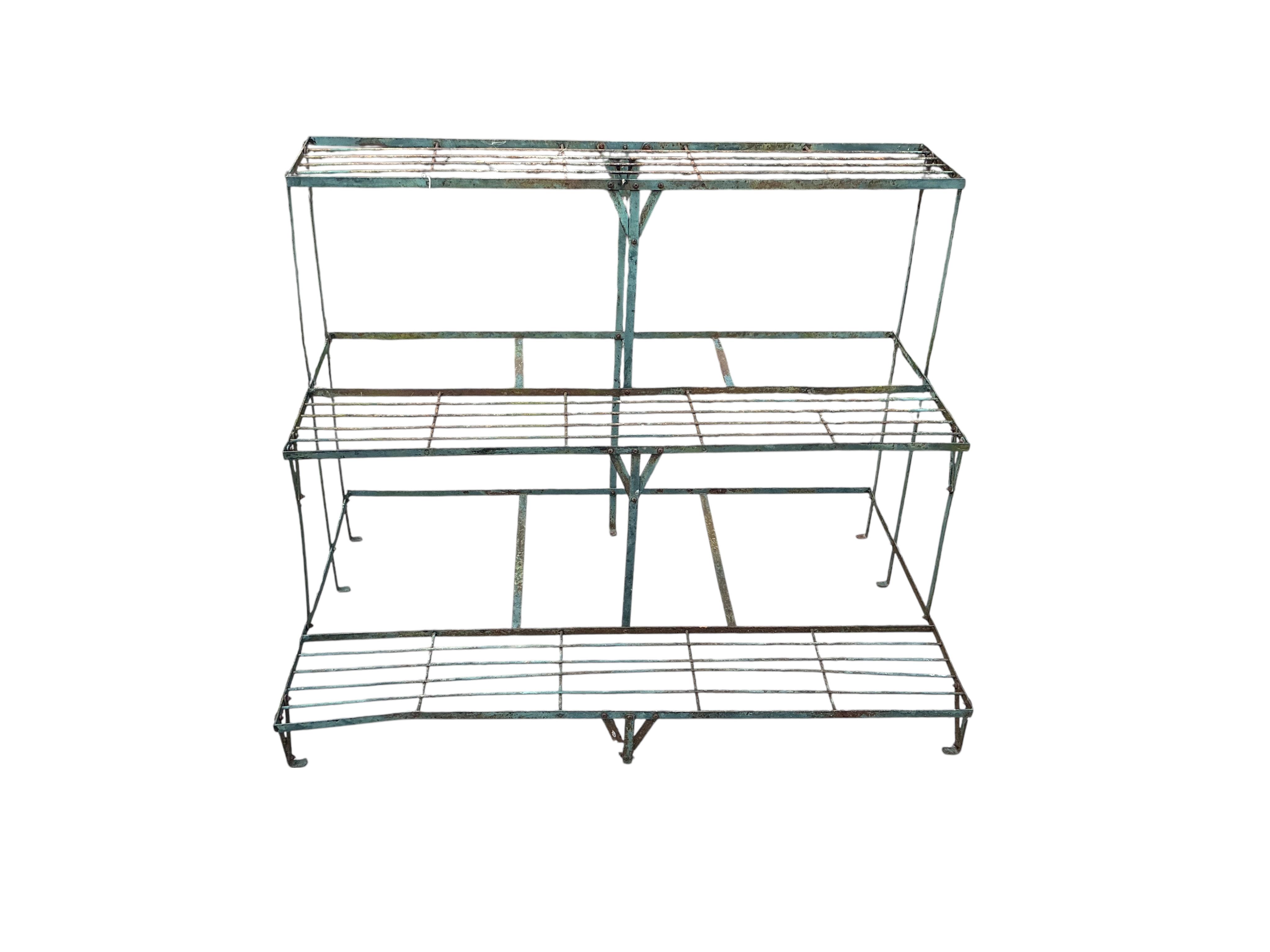 A wrought iron three section three tier pot stand, width 108cm, height 75cm